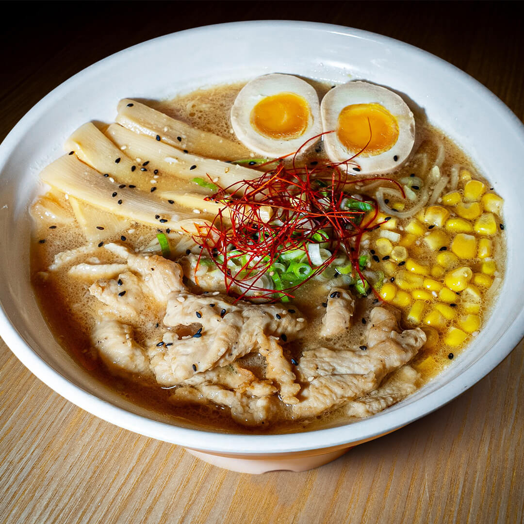 Miso Ramen Chicken Miami A bowl of Miso Ramen from 107 Taste in Miami, topped with sliced chicken, corn, a soft-boiled egg, and fresh scallions.