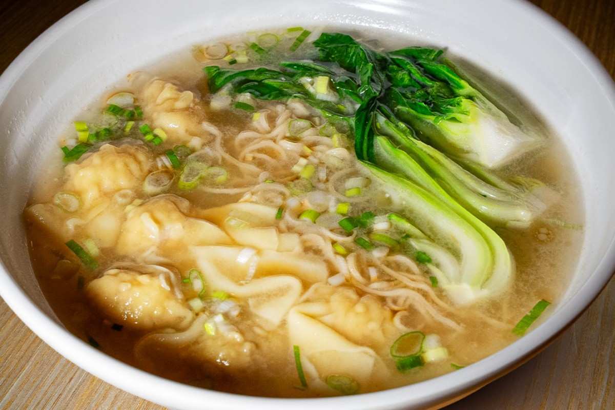 Close up of the best handmade wonton noodle soup in Miami featuring plump shrimp dumplings and bok choy at 107 Taste